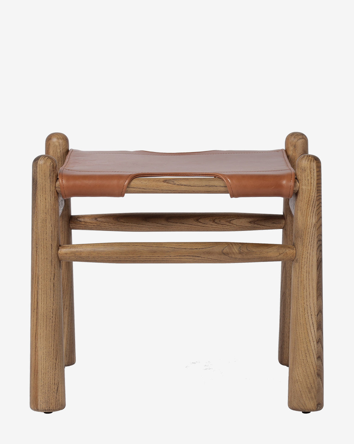The Tierney Ottoman by Four Hands features a minimalist, rustic design with four sturdy legs, two horizontal support bars, and a top grain leather seat stretched over solid wood. Vendixs