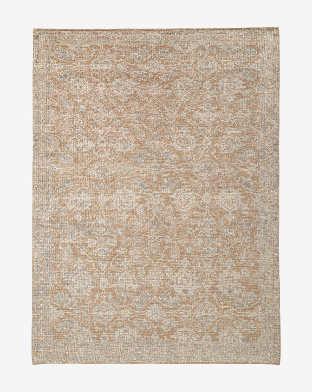 The Vanderwood Hand-Knotted Wool Rug showcases a vintage, distressed look with an intricate faded floral and vine pattern in beige and light blue, darker edges, and a symmetrical design that enhances its timeless, traditional charm, by Vendixs