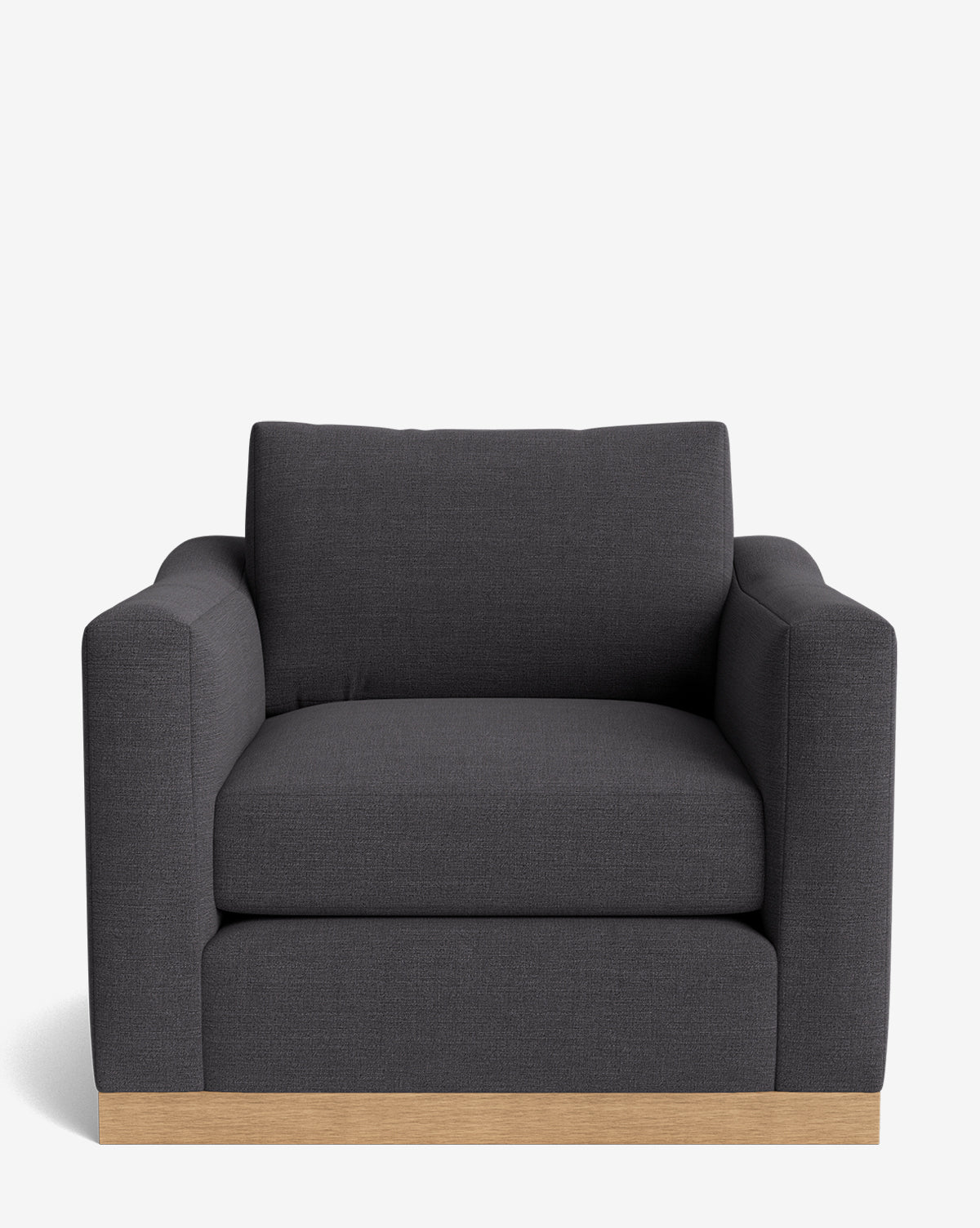 A front view of the Vernon Lounge Chair, featuring dark gray upholstery, thick cushions, wide armrests, and a light alder wood frame base against a white background. Customizable upholstery options available, by McGee & Co.