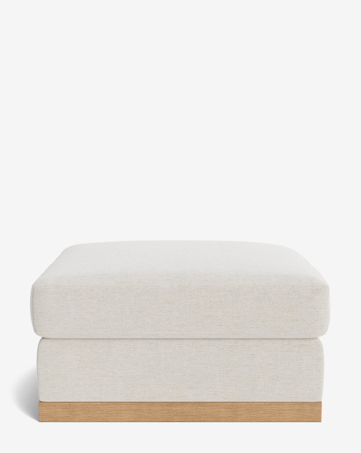 The Vernon Modular Ottoman is a rectangular, light beige ottoman with a minimalist design, featuring a low wooden base and smooth cushioned top, shown against a plain white background by McGee & Co.