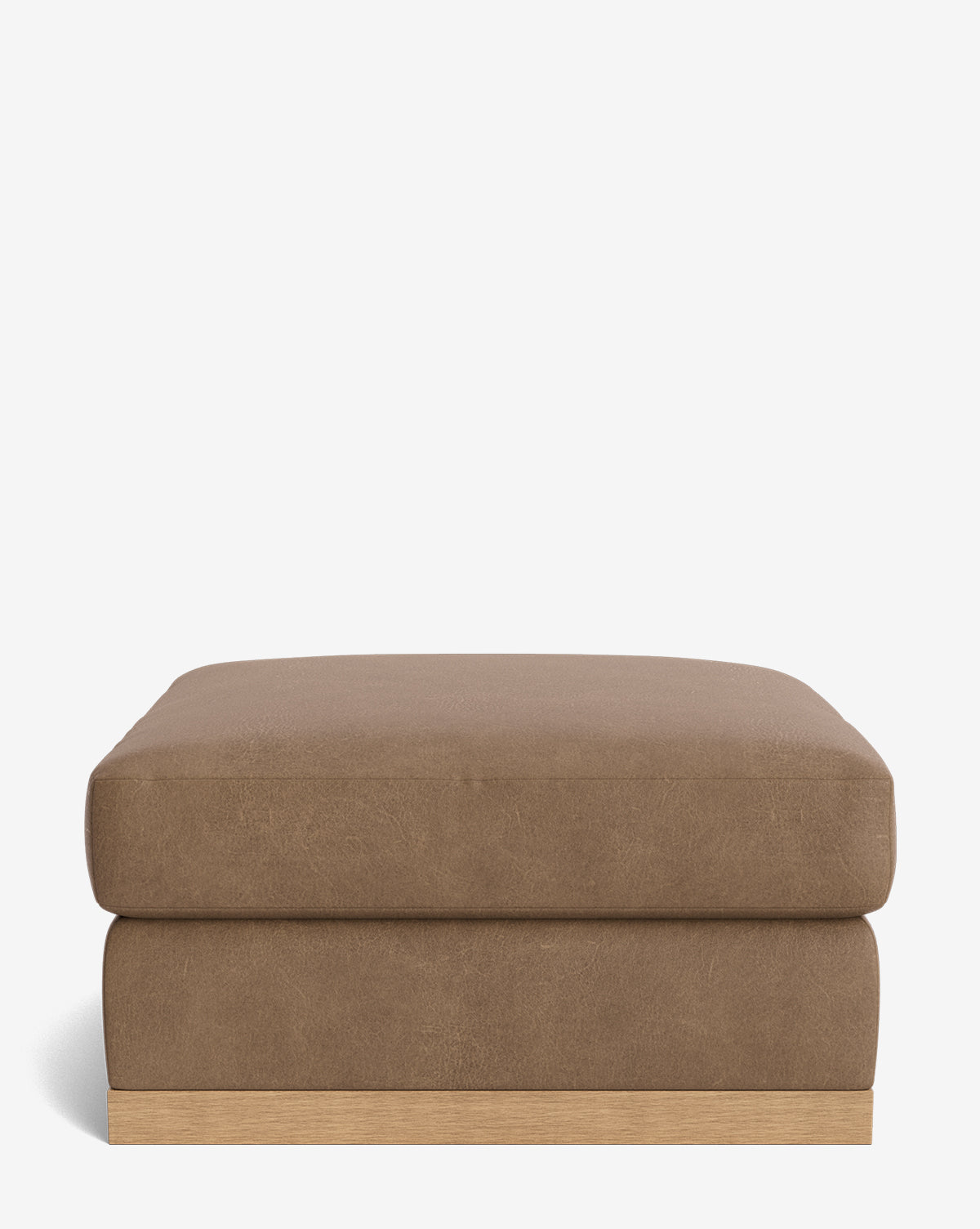 The Vernon Modular Ottoman is a square brown piece with a cushioned top, upholstered in leather or faux leather, and features a light wood base, shown against a plain white background by McGee & Co.