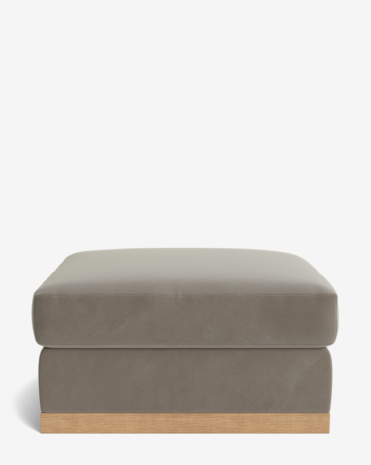 The Vernon Modular Ottoman is a square, taupe velvet piece with a smooth cushion and low wooden base, shown against a plain white background by McGee & Co.