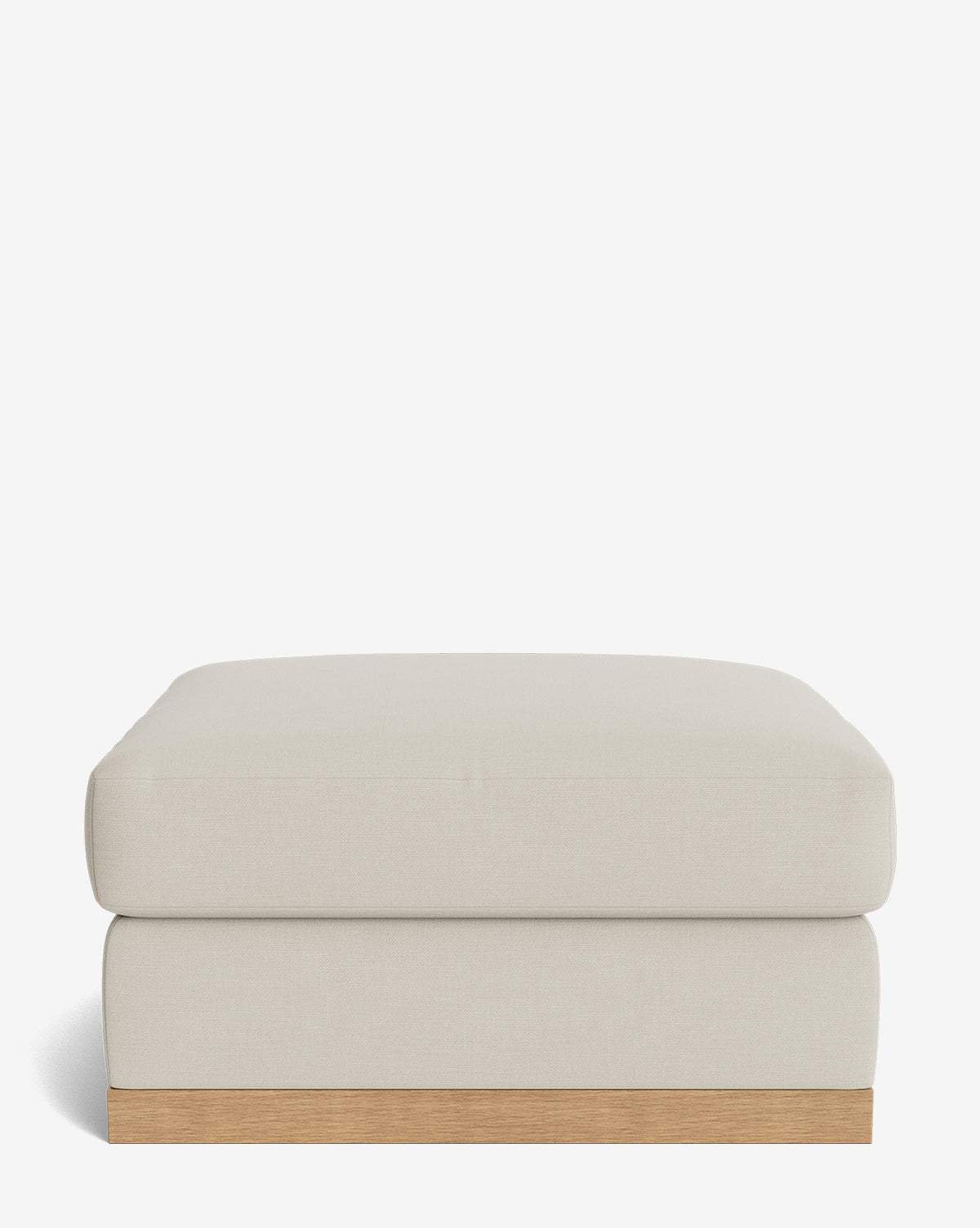 The Vernon Modular Ottoman features a modern rectangular design with light beige upholstery and a wooden base, displayed against a plain white background, by McGee & Co.