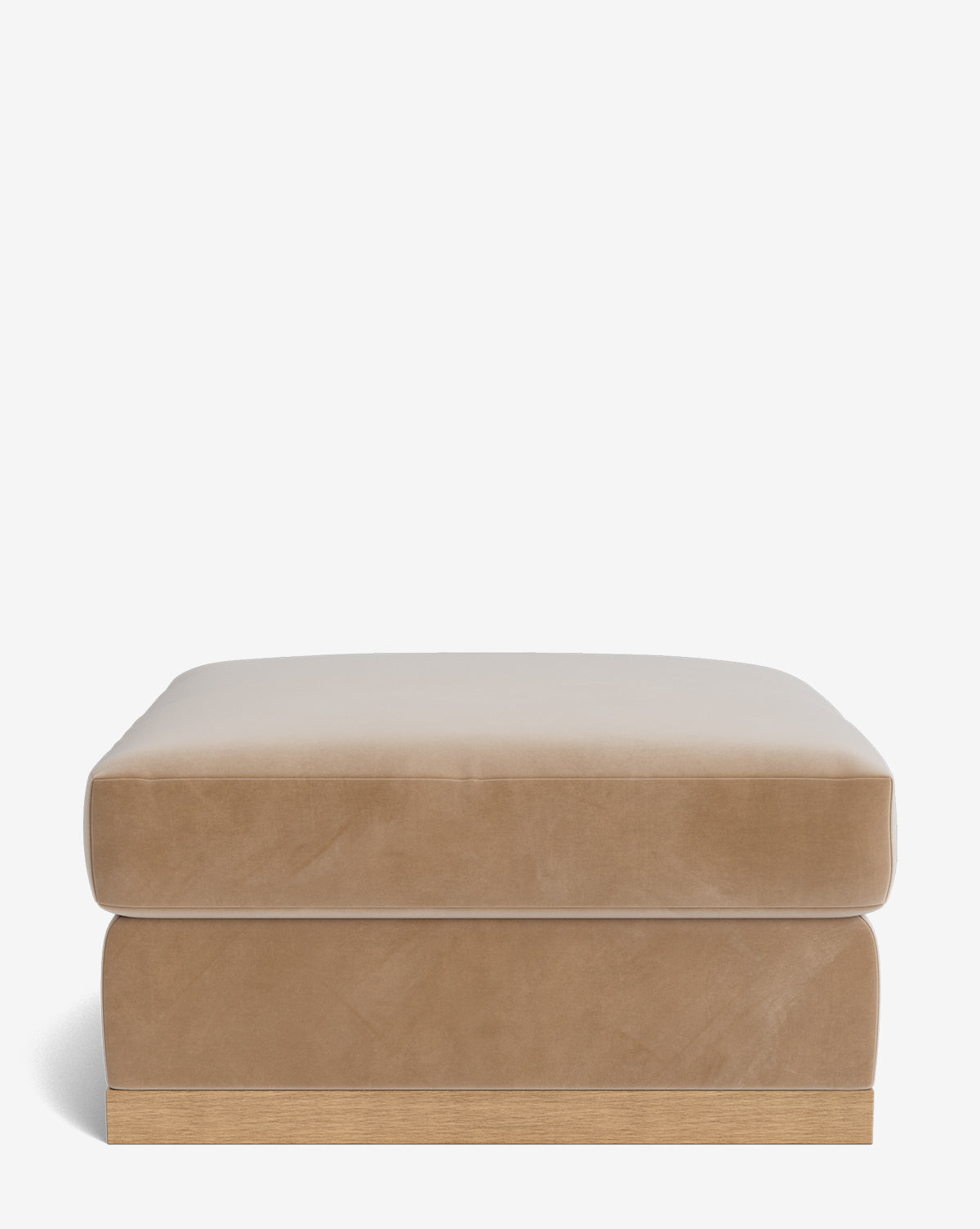 The Vernon Modular Ottoman is rectangular and tan, featuring a soft cushion top and a light wooden base, shown against a plain white background by McGee & Co.
