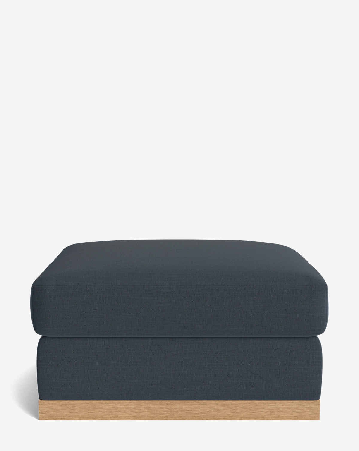 The Vernon Modular Ottoman features a modern rectangular design with dark blue velvet upholstery and a light wood base, displayed against a plain white background by McGee & Co.
