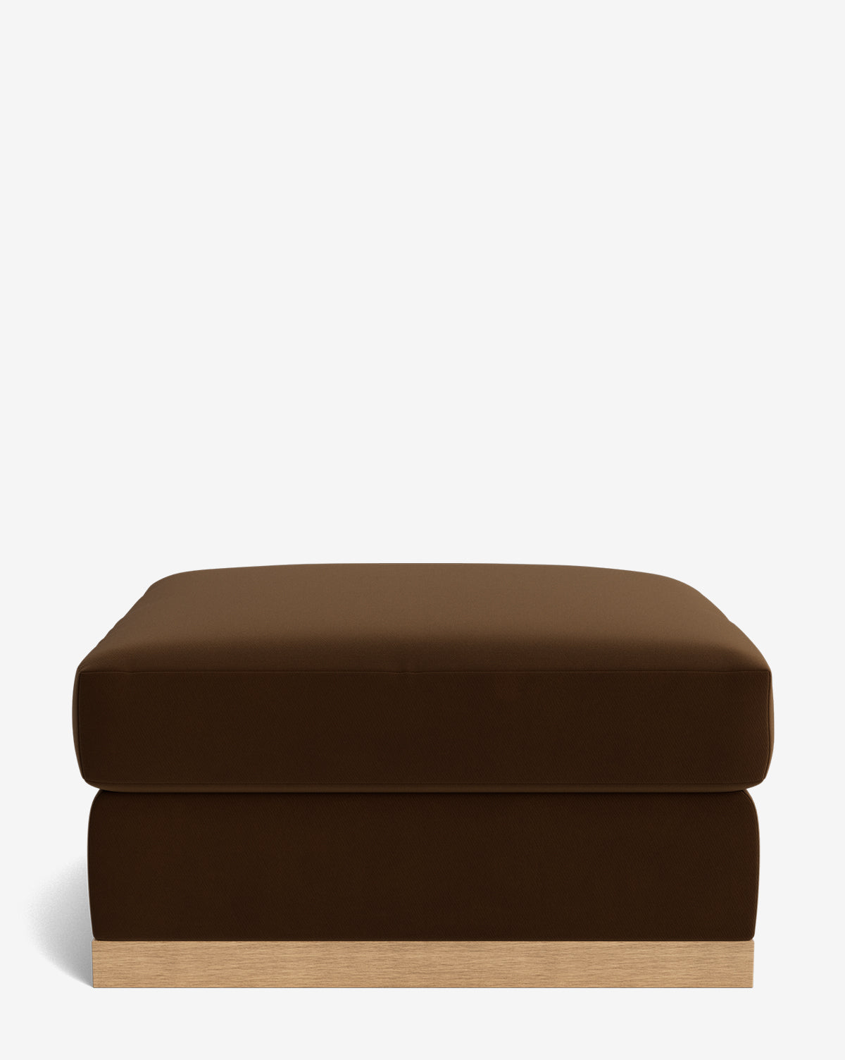 The Vernon Modular Ottoman features a large, rectangular cushioned top in dark brown velvet and a light wood base, displayed against a plain white background, by McGee & Co.