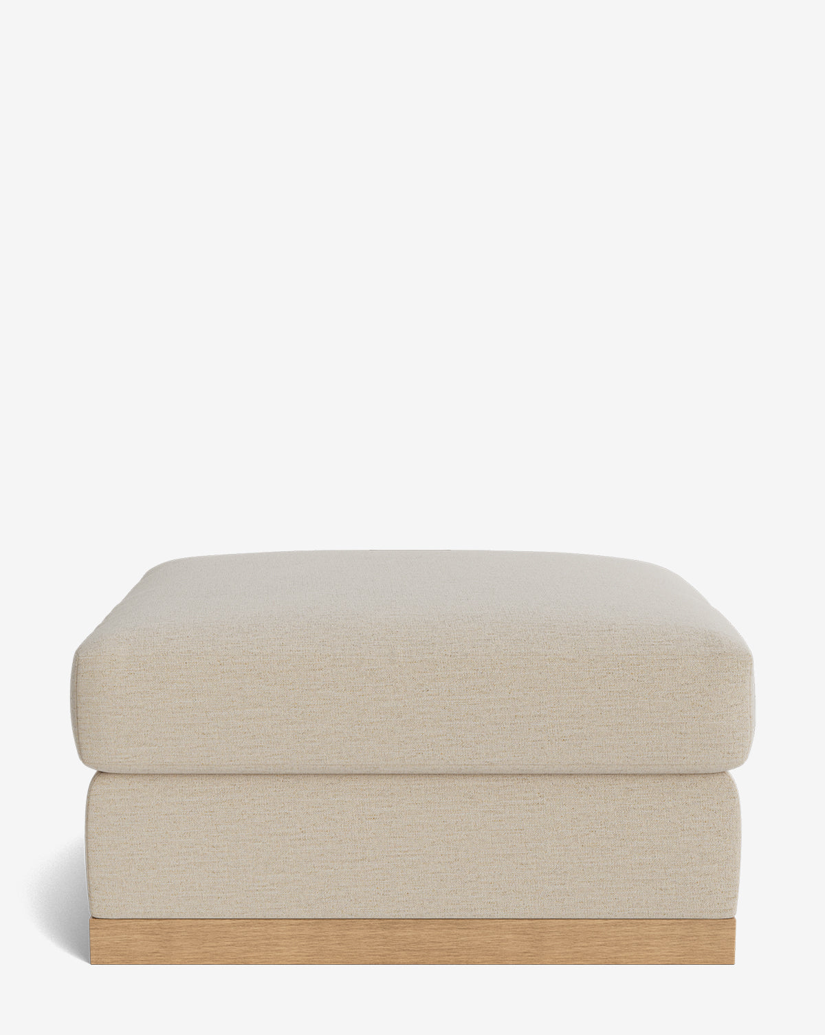 The Vernon Modular Ottoman is a square, beige piece with a soft upholstered cushion and wooden base, shown against a plain white background, by Vendixs