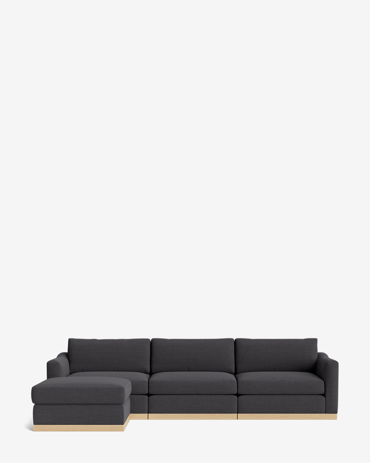 The Vernon Modular Sofa with Ottoman 121 is a modern dark gray sectional with a left chaise and light wood base, shown on a plain white background. This customizable fabric sofa offers stylish versatility for contemporary spaces, by Vendixs