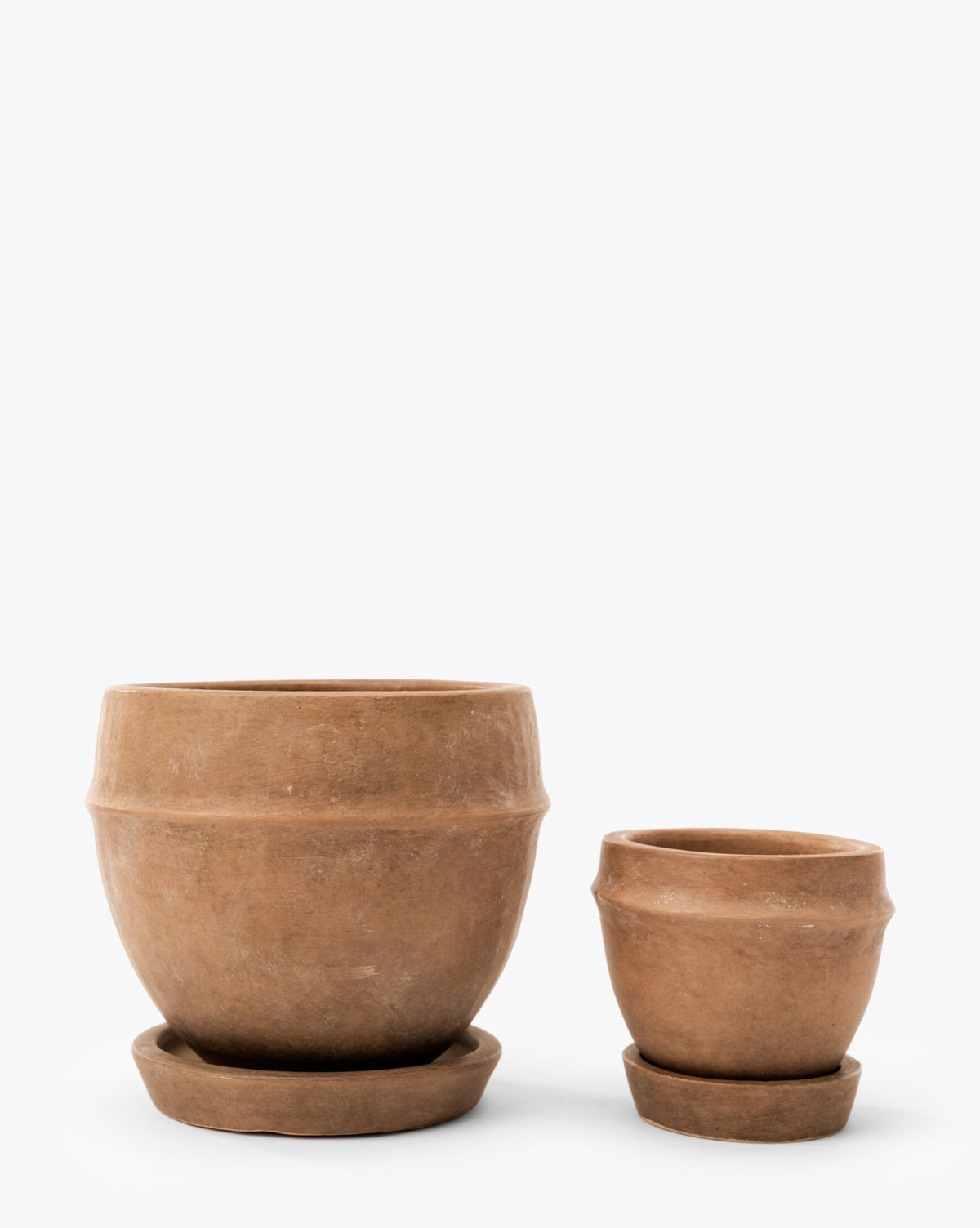 Two Vichy Terracotta Planters by Terra Cotta Art Works, Inc.—one large and one small—feature a simple, rustic design with matching saucers, perfect for indoor or outdoor plants. Shown side by side on a white background. Vendixs