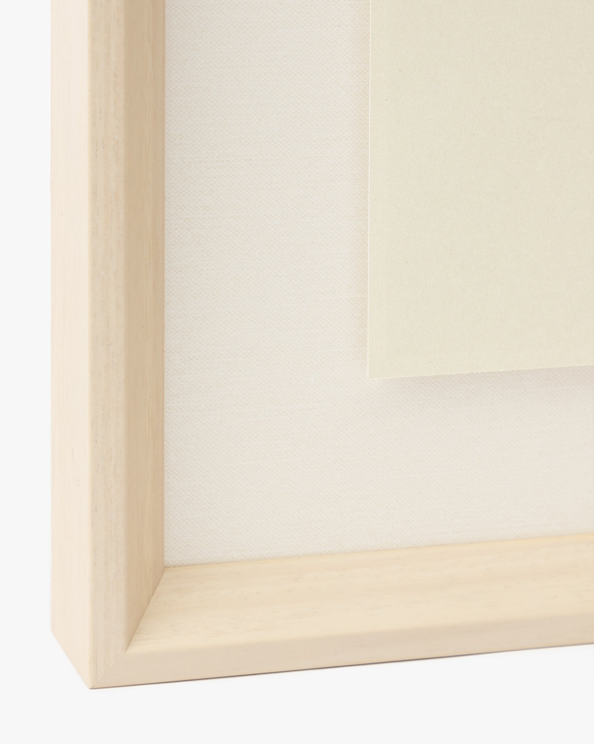 Close-up of a light wooden frame with a white textured background and off-white paper, perfect for displaying the Watermelon Collage giclee print in a childrens room, by Vendixs