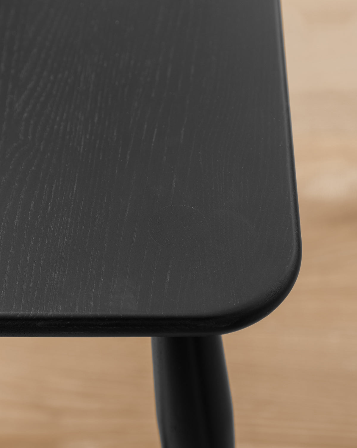 Certainly! Here’s your revised product description with the exact string Vendixs seamlessly blended at the end: --- Close-up of the Whittaker Counter Stool by YANG CHENG WOODEN INDUSTRIES INTERNATIONAL (VIETNAM) CO LTD, featuring a solid black oak seat with smooth, rounded edges and visible wood grain. The background is softly blurred in a light brown hue. Vendixs