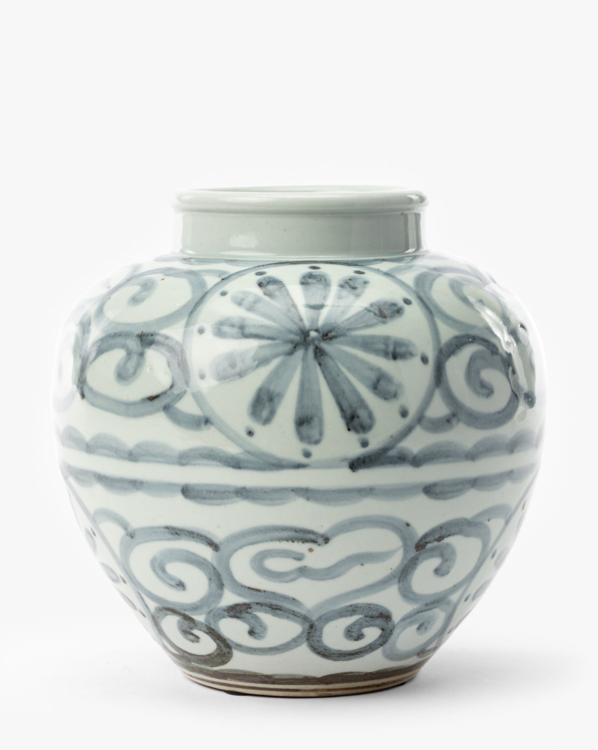 The Wilfred Vase is a round ceramic jar with a short, wide neck, featuring blue floral and swirling cloud designs on a glossy white background. It sits on a flat surface against a plain white backdrop, by Vendixs
