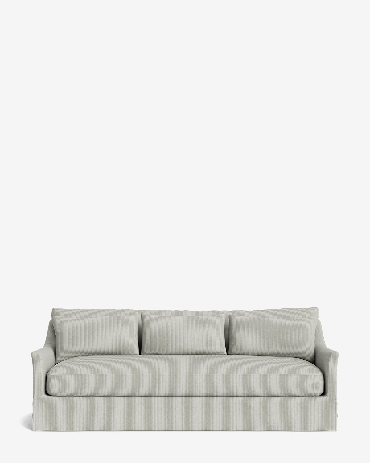 The Wilhelmina Deep Slipcover Sofa (85-110) is a light gray three-seat sofa with a skirted base and three back cushions, offering luxurious comfort against a plain white background by Vendixs