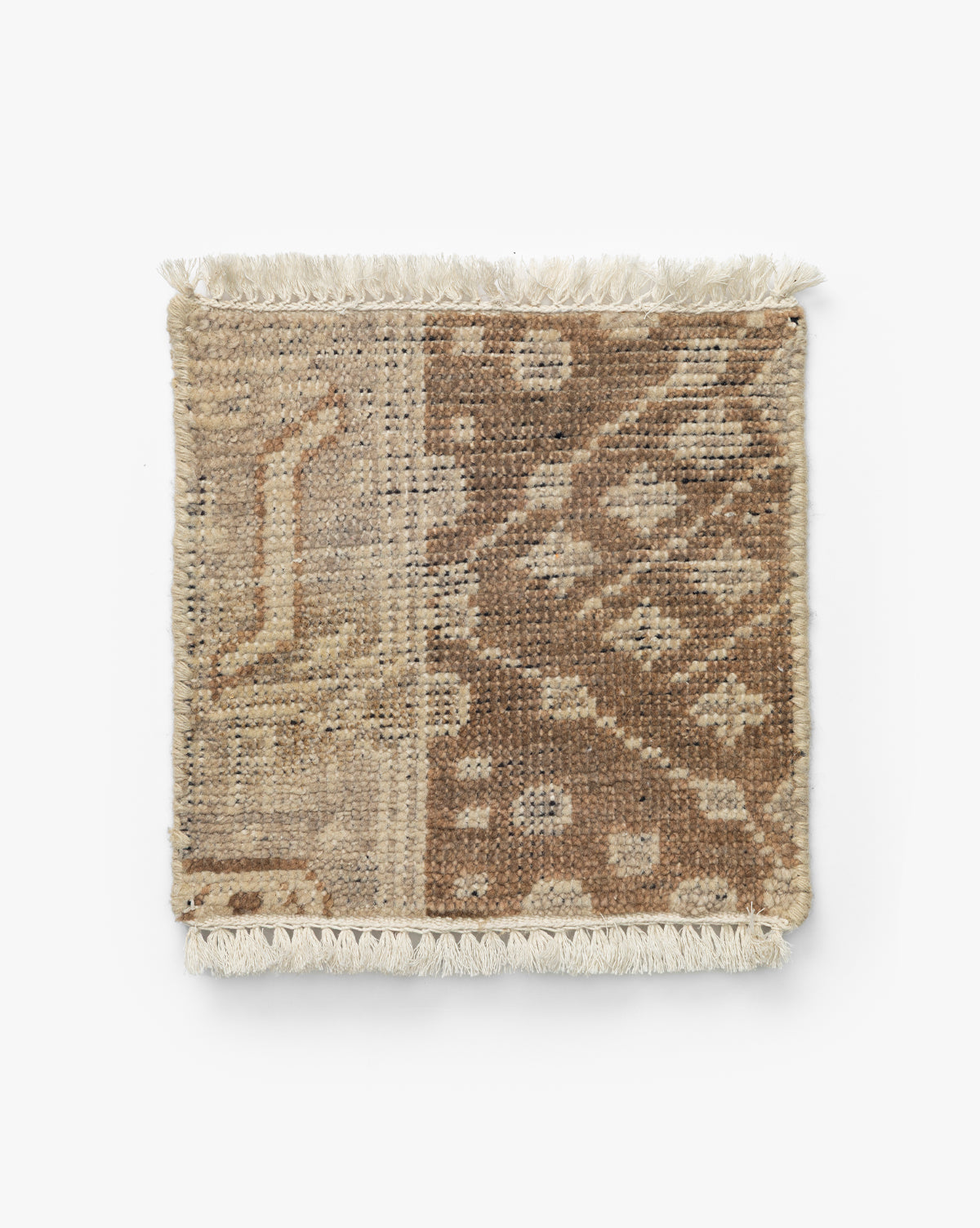 The Windsor Hand-Knotted Wool Rug Swatch is an artisan-crafted, square woven sample with tasseled edges, showcasing a beige and brown patchwork of geometric and abstract patterns, by Vendixs