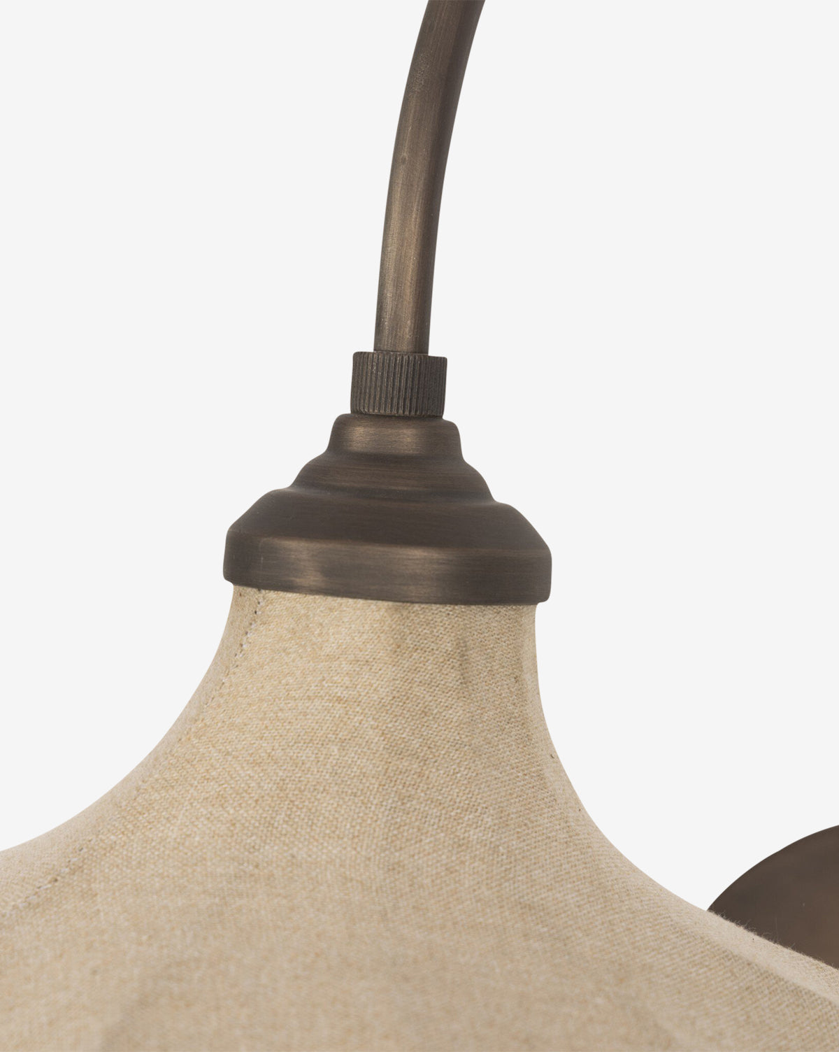 Close-up of the Winslet Sconce's linen lampshade with a textured beige surface and a dark bronze fixture connecting to its curved arm, shown against a plain white background, by McGee & Co.