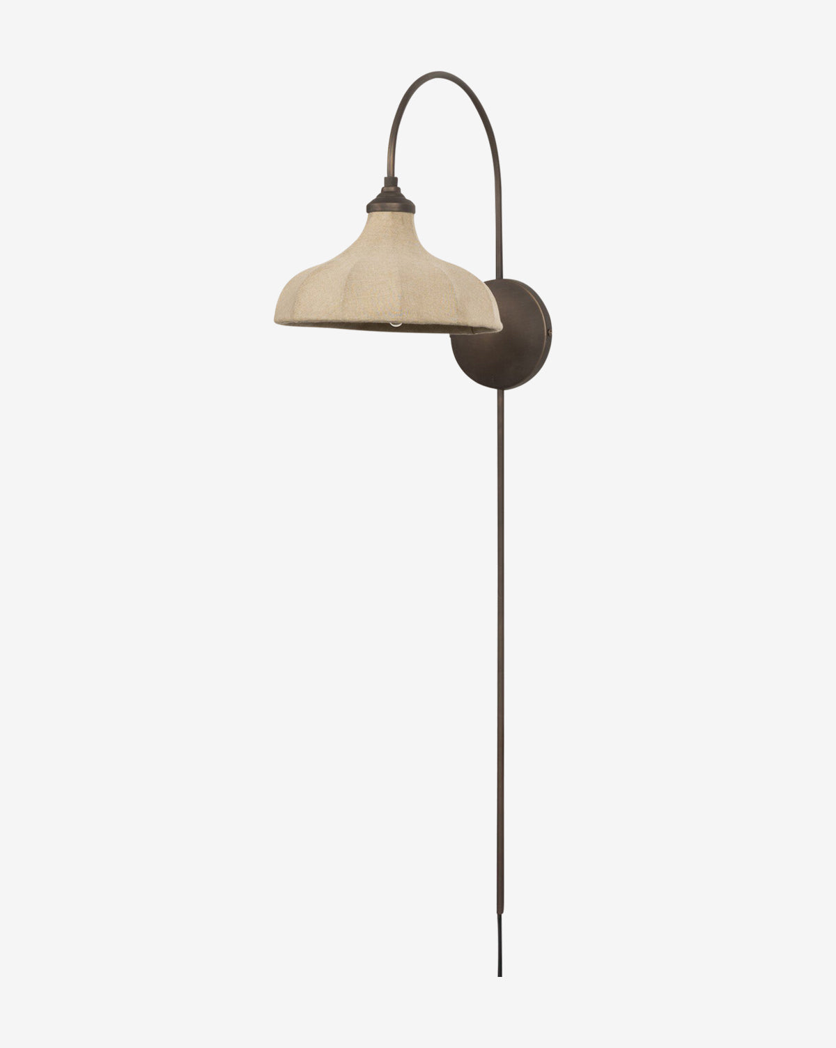 The Winslet Sconce by Four Hands is a wall-mounted brass light with a curved metal arm, wide beige linen shade, dark round base, and long vertical rod. This plug-in sconce stands out against a plain white background. Vendixs