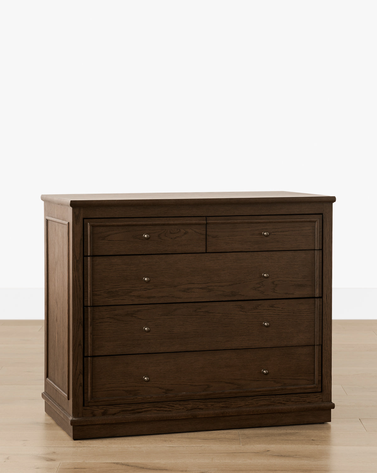 The Yorkshire Dresser in dark brown English oak features two small top drawers and three larger lower drawers with round metal knobs, providing elegant bedroom storage on a light wood floor against a white background, by Vendixs