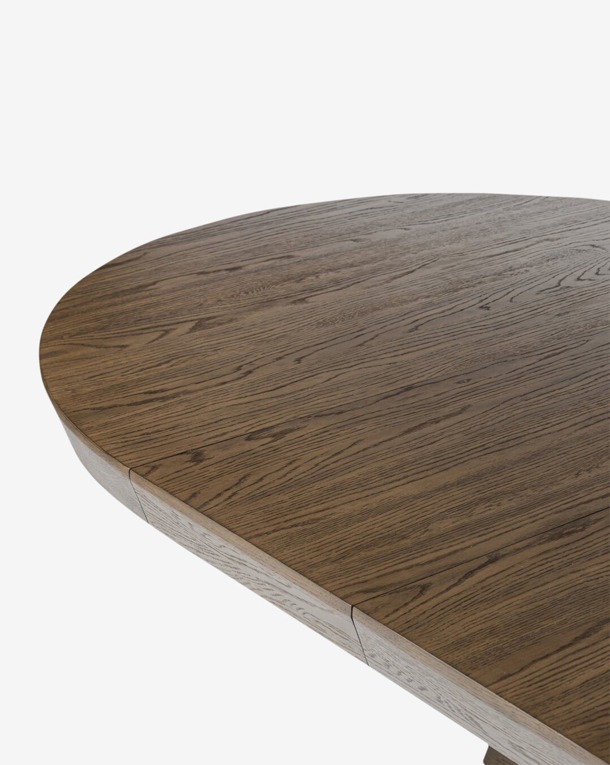 Close-up of the Yvonne Dining Table with smooth, rounded edges and visible oak grain, showcasing its natural texture. The dark finish contrasts sharply against the plain white background, by McGee & Co.