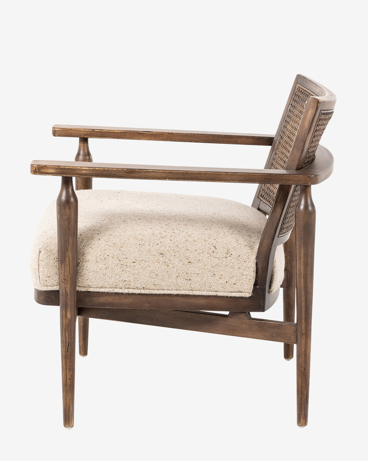 Side view of the Zalan Lounge Chair, showcasing a woven cane back, light beige Belgian linen seat cushion, angled legs, and curved armrests in a mid-century modern design, by Vendixs