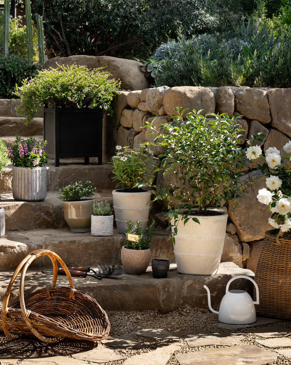 Allston Planter in terracotta finish, shown on a patio with other outdoor decor, from Vendixs