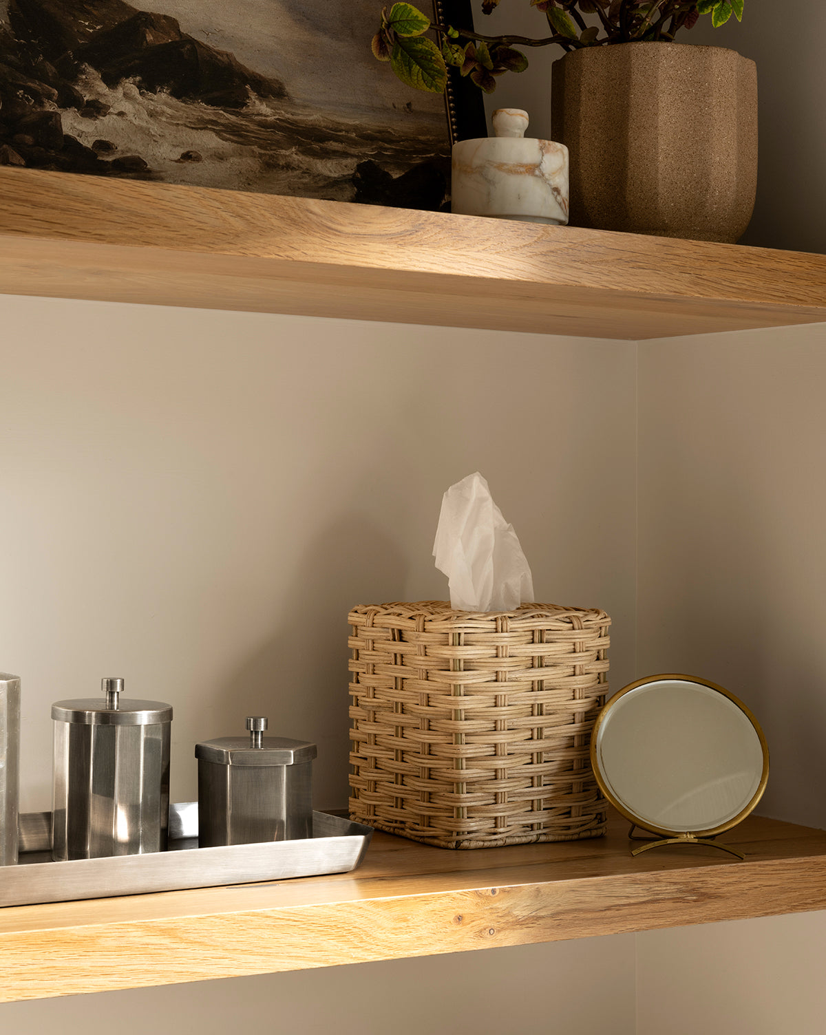 Above, a plant and art piece complete this stylish bathroom counter decor, by Vendixs