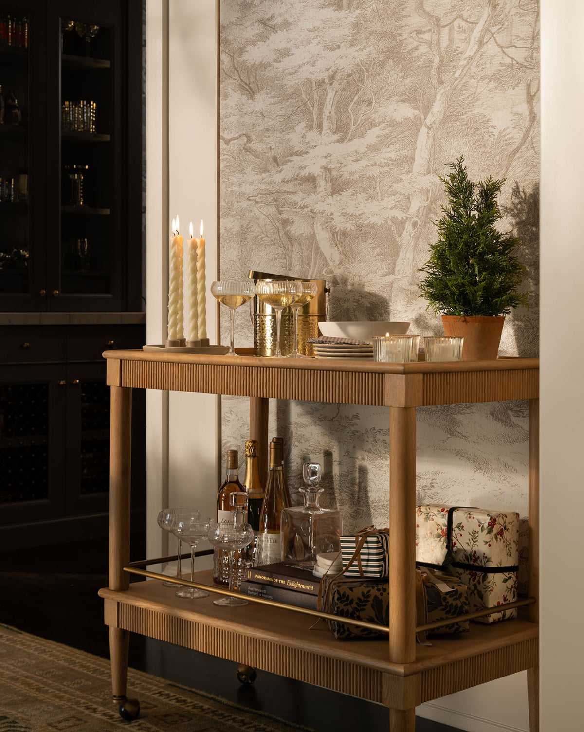 It stands before tree-patterned wallpaper for a cozy and elegant touch, by Vendixs