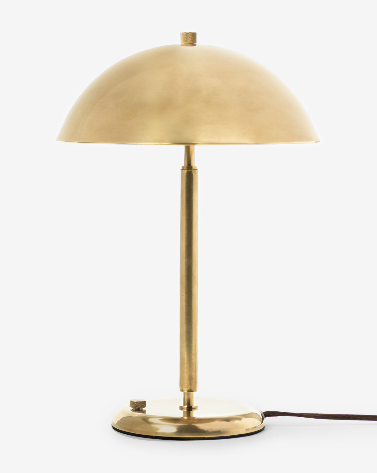 The Aldorno Desk Table Lamp features a brass finish, dome-shaped shade, slender stem, and round base against a plain white background. A black power cord extends from the base—ideal as a modern accent for any space, by Vendixs