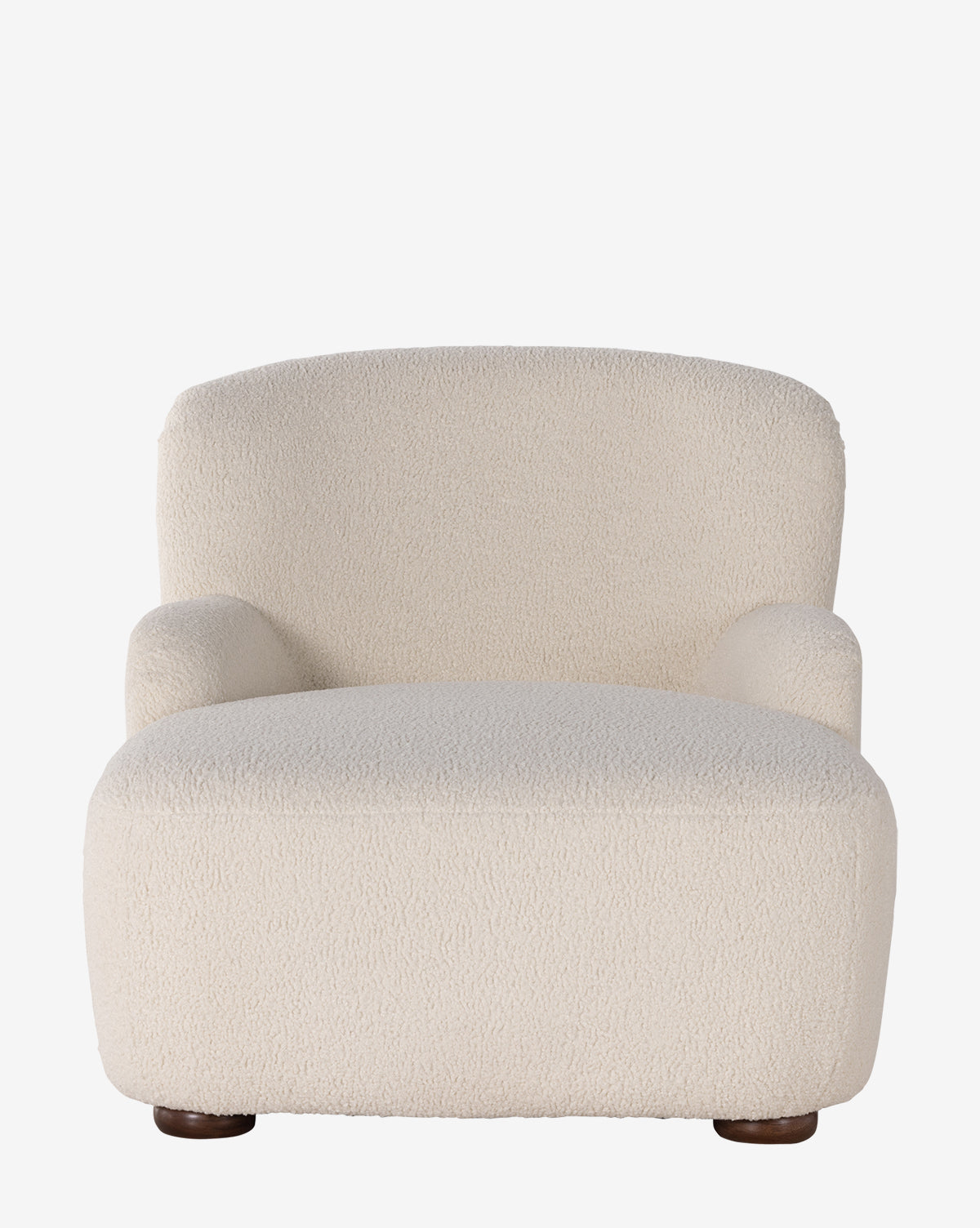 The Berrett Chaise Lounge is a plush, modern seat upholstered in textured off-white shearling with rounded arms, a low wide seat, and short dark wood legs—perfect for elevating any living space, by Vendixs