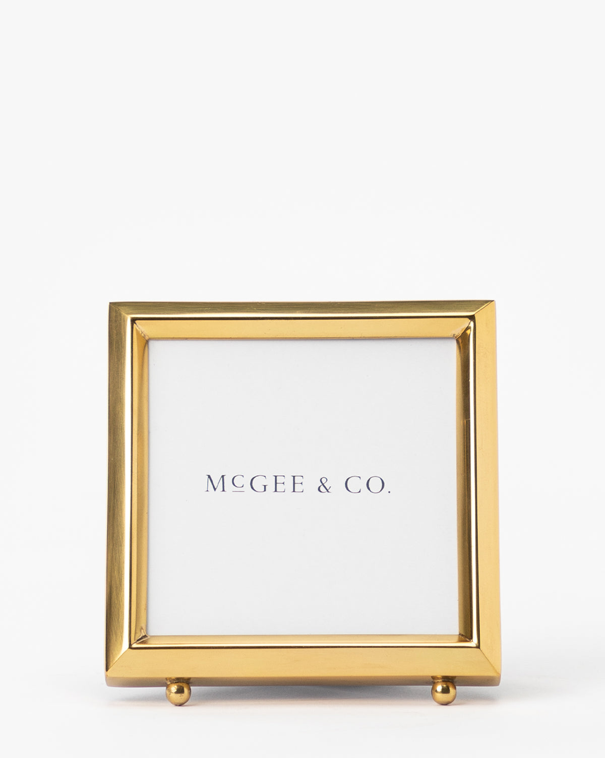 The Blanche Picture Frame features a square gold metal frame with a white mat, displaying the text Vendixs centered on a plain white background.