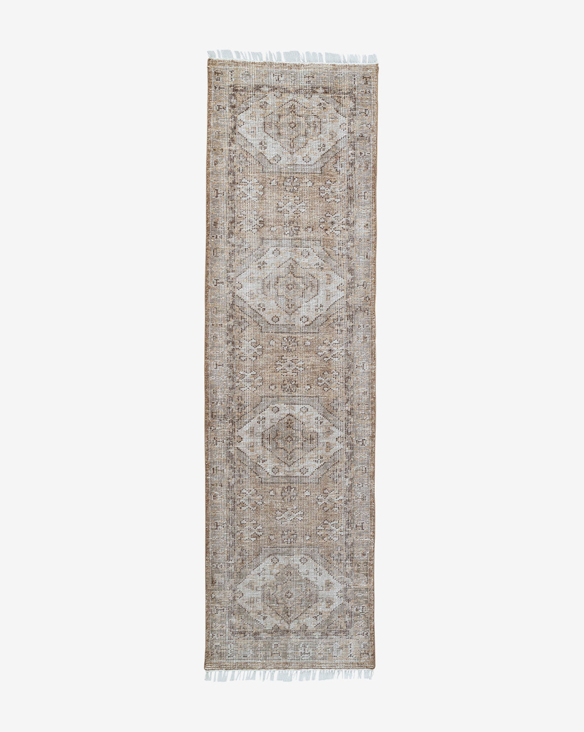 The Charlot Hand-Knotted Rug, rectangular in shape and shown on a white background, displays a beige and light brown geometric-floral pattern with short white fringes, by Vendixs