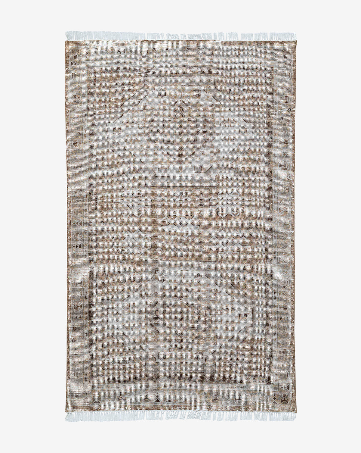 The Charlot Hand-Knotted Rug is a rectangular vintage piece in beige and light brown, featuring a faded geometric pattern with two central diamond shapes and fringed edges, by Vendixs