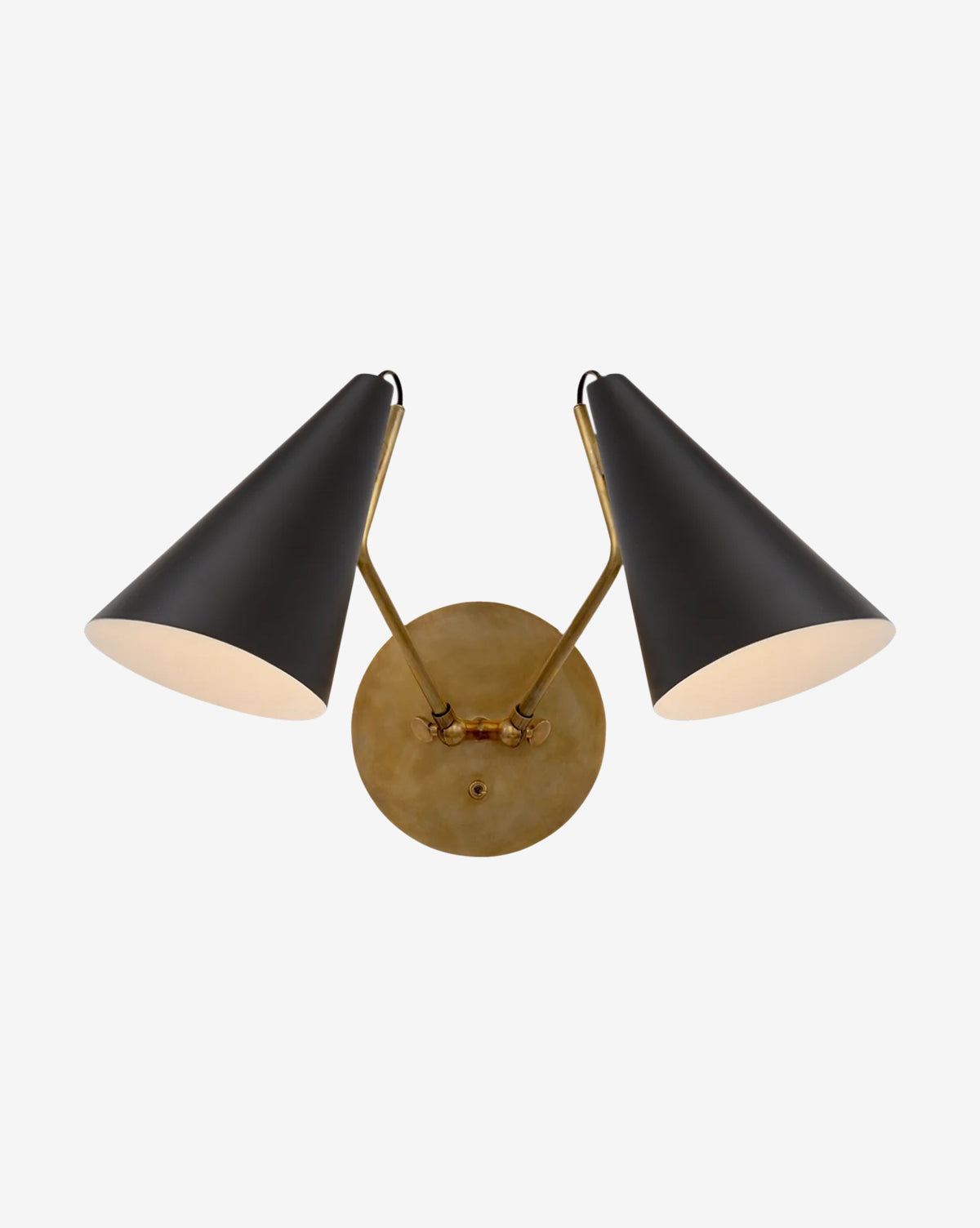 The Clemente Double Sconce by Visual Comfort & Co. Signature features two black, cone-shaped shades angled outward on a round, hand-rubbed brass base, offering an elegant lighting solution for any room by Vendixs