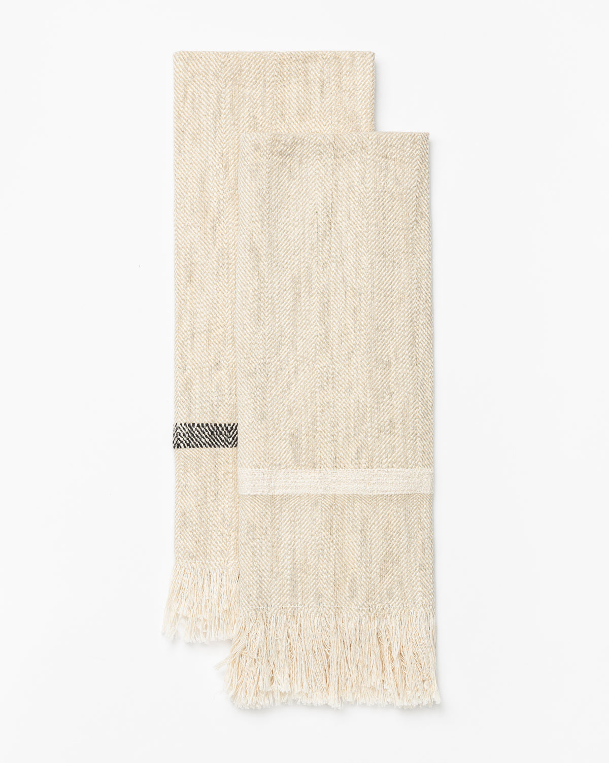 A set of two beige Fringed Striped Tea Towels, each with a subtle herringbone pattern and black-and-white detail, crafted from soft cotton with fringed edges, is displayed flat on a white background, by Vendixs