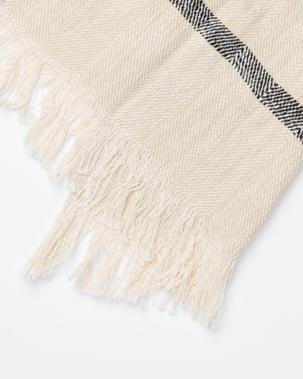 A close-up of the Fringed Striped Tea Towel (Set of 2) shows its beige color, subtle chevron pattern, fringed edges, and a single black stripe—an elegant accent for any kitchen décor, by Vendixs