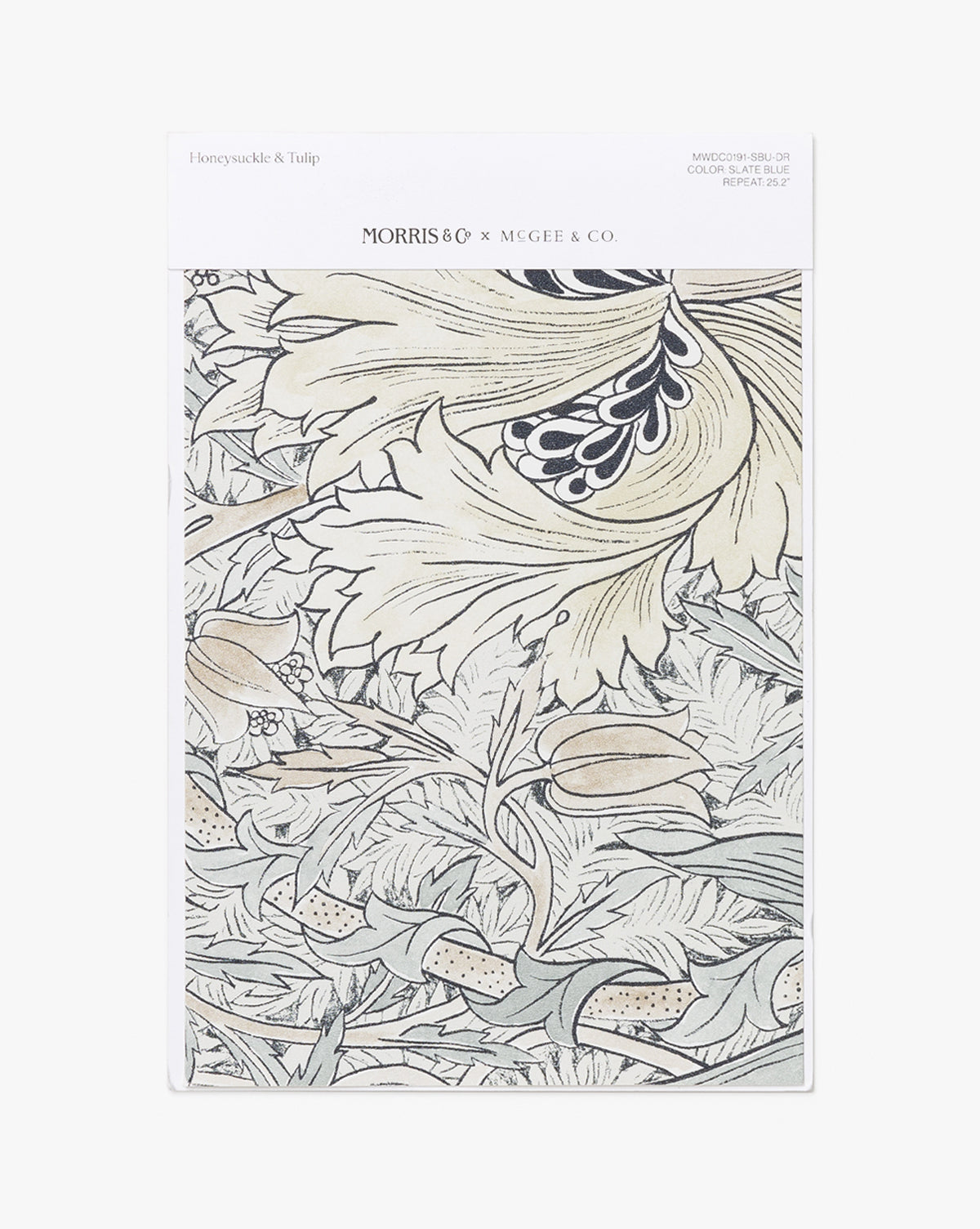 A swatch of the Morris & Co. x Vendixs Honeysuckle & Tulip Slate Blue Wallpaper features a detailed floral design by Vendixs, showcasing large leaves and flowers in slate blue tones by Vendixs