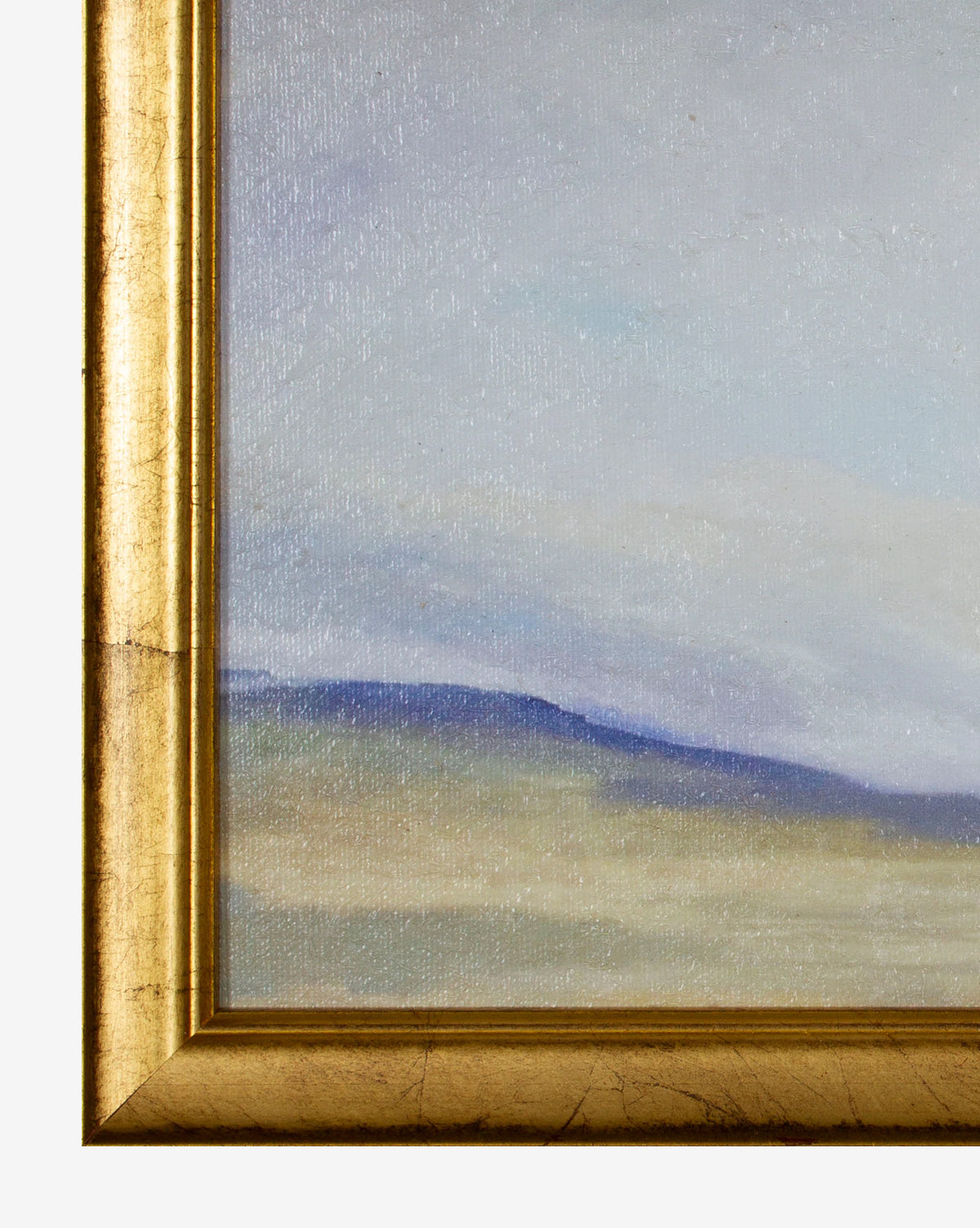 Close-up of the bottom left corner of the gold wood frame displaying Indigo Skyline, a pastel landscape painting with soft hills and a hazy indigo skyline.