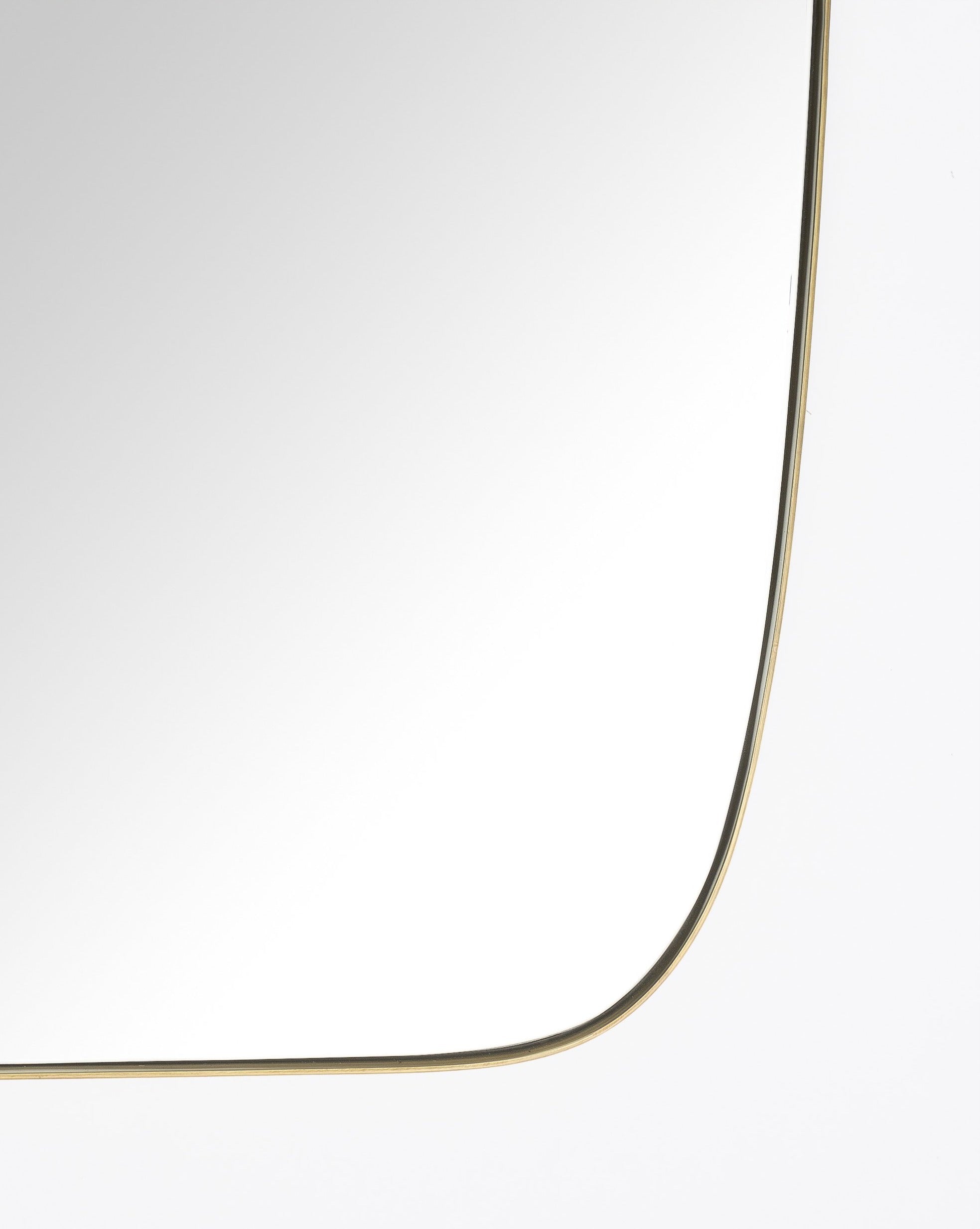 A close-up of the Jace Inset Mirror highlights its slim, gold stainless steel frame and rounded corner, set against a plain white background, by Vendixs