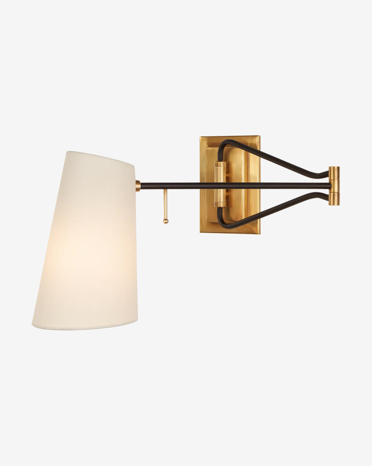 The Keil Swing Arm Wall Light by Visual Comfort & Co. Signature features an antique brass base, black metal arm, and white linen shade, illuminated against a plain light background. Vendixs