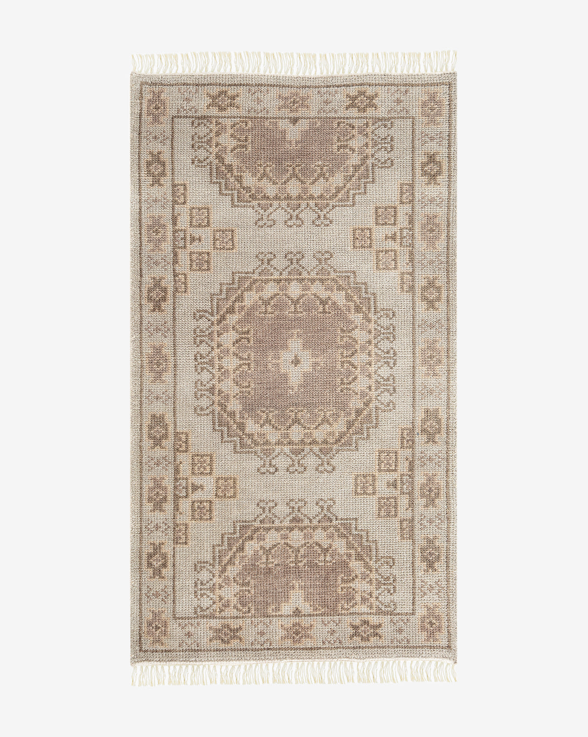 The Kenna Hand-Knotted Wool Rug features a rectangular shape, traditional geometric and floral patterns in beige and taupe, hand-knotted craftsmanship, and fringed edges on the shorter sides, by Vendixs