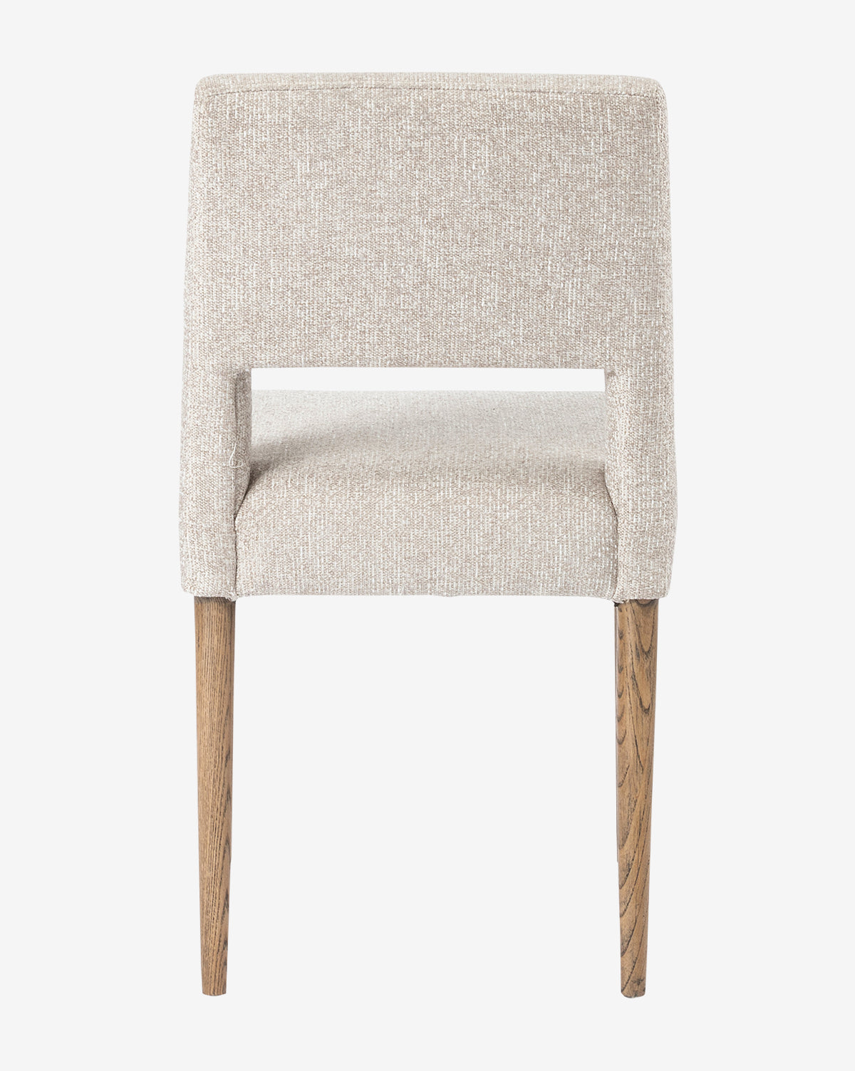 The Kiernan Dining Chair features textured light beige fabric, a straight backrest, and two visible wooden legs, shown from the back against a plain white background by Vendixs