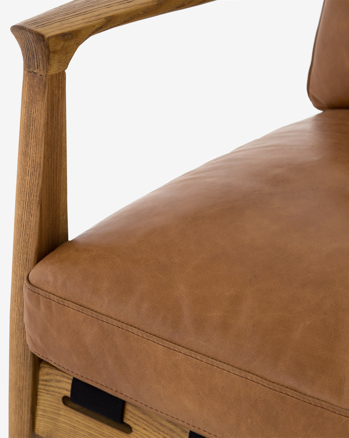 Close-up of the Lanston Lounge Chair with an ash wood frame and tan leather cushions, focusing on the armrest, seat, and backrest details against a light background, by Vendixs