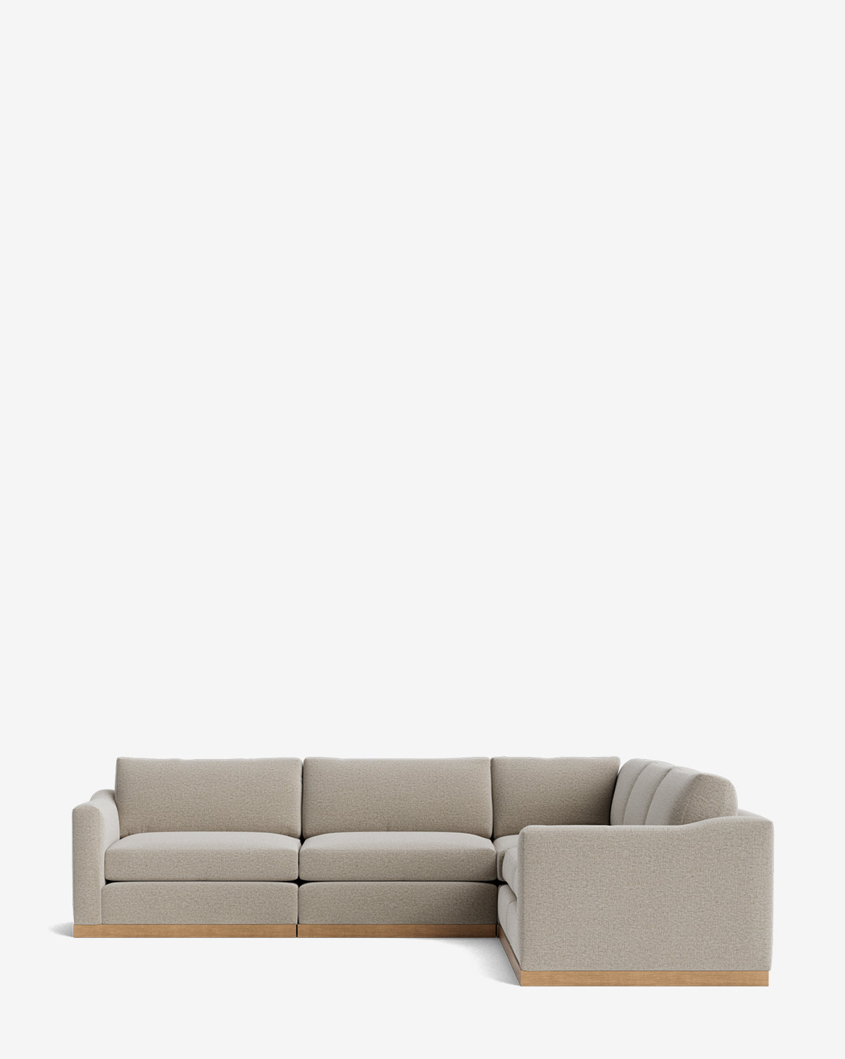 The Community Vernon Modular L Sectional 117.5 features light gray upholstery and a wooden base, offering customizable comfort and modern style, shown here against a plain white background. Vendixs