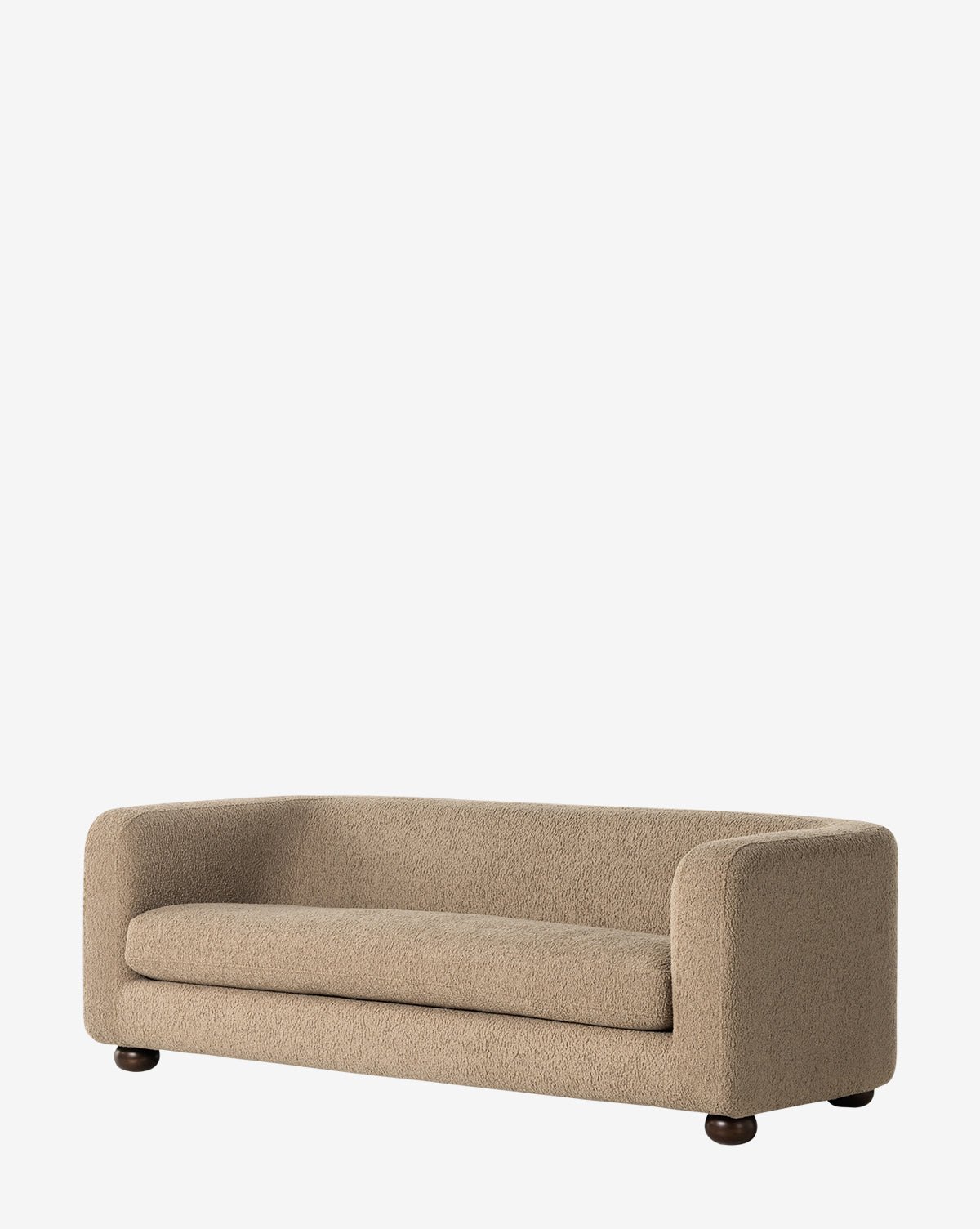 The Quill Sofa 84 by Four Hands is a modern beige faux shearling sofa with rounded edges, a low profile, and textured upholstery on dark, short, round legs set against a plain white background. Vendixs