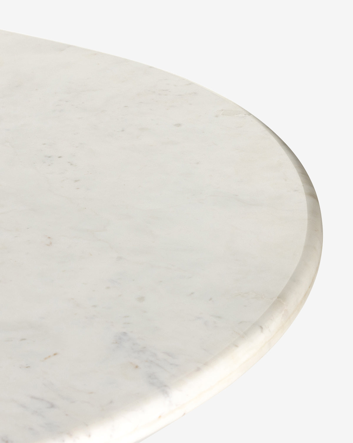 Close-up of the Patrick Dining Table, a round white marble piece with subtle gray veining and a smooth, polished edge, highlighting refined Italian design against a plain white background, by Vendixs