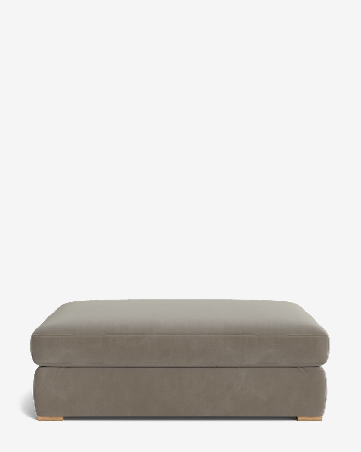 The Macy Upholstered Ottoman by Community is a large, rectangular taupe piece with a smooth surface and low wooden feet, ideal as versatile living room furniture, shown against a plain white background by Vendixs