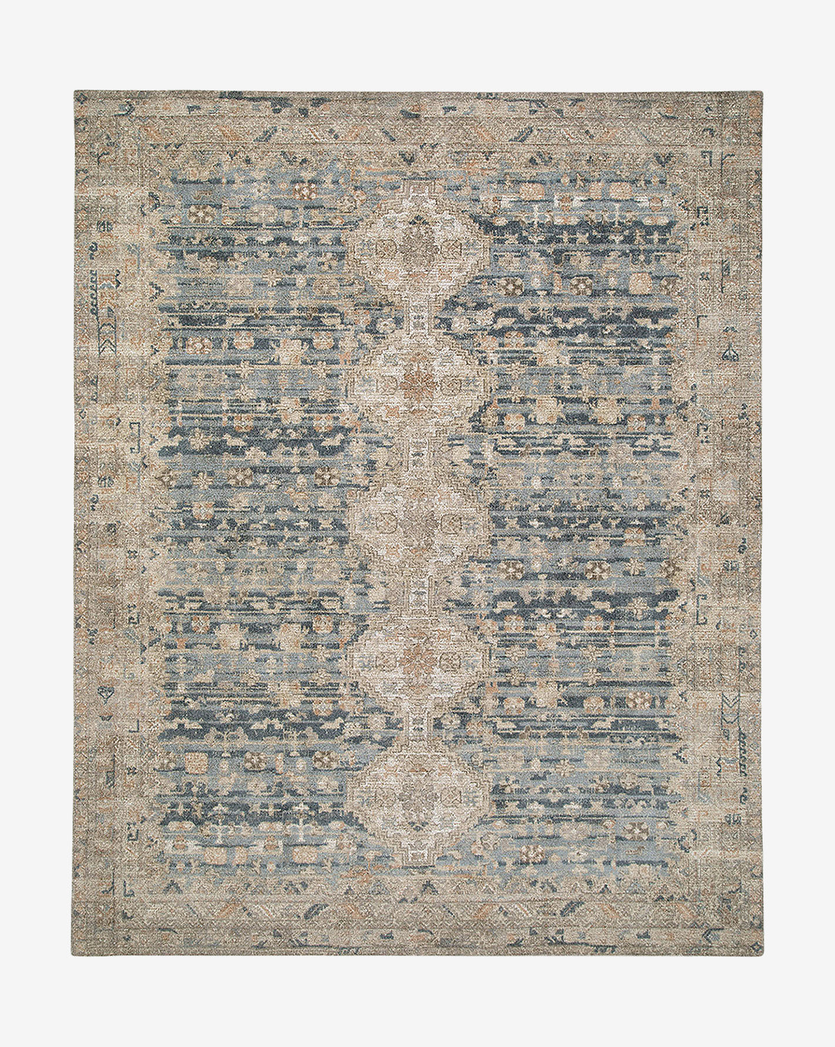 The Wilshire Blue Hand-Tufted Wool Rug features a rectangular shape, distressed vintage-style design in muted blue, beige, and tan, with a central medallion pattern and intricate borders, by Vendixs