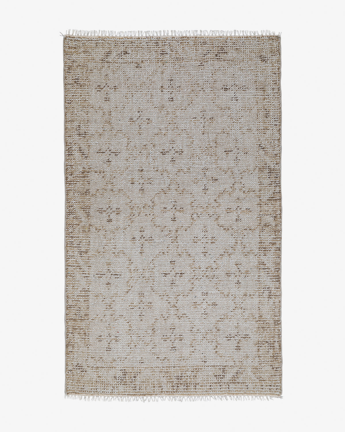 The Mali Hand-Knotted Rug is a rectangular neutral piece with a beige and brown geometric pattern and fringed short edges, shown on a white background, by Vendixs