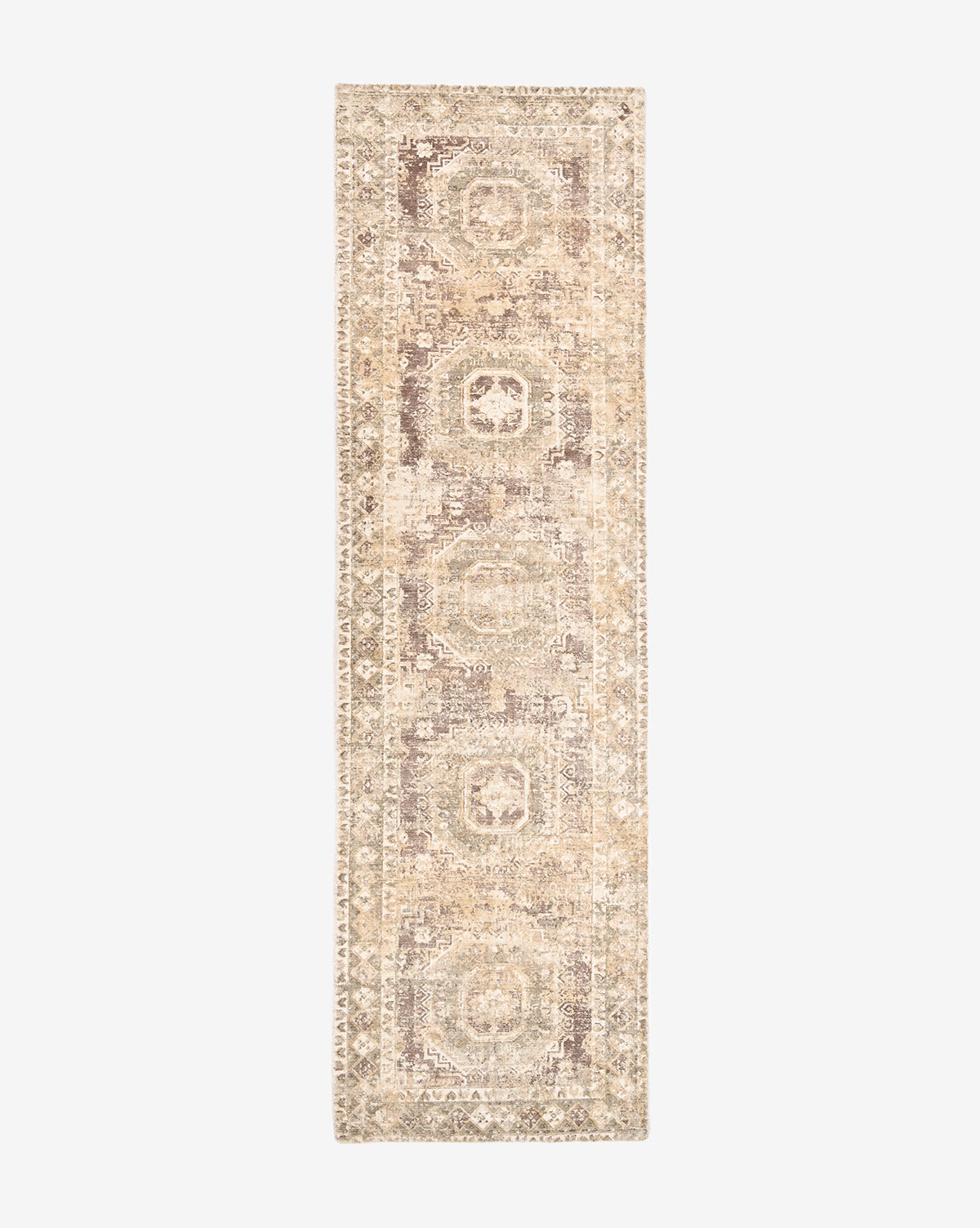 The Marcella Handwoven Rug is a long, narrow, neutral tan wool blend runner featuring a faded geometric pattern and intricate border on a white background, by Vendixs