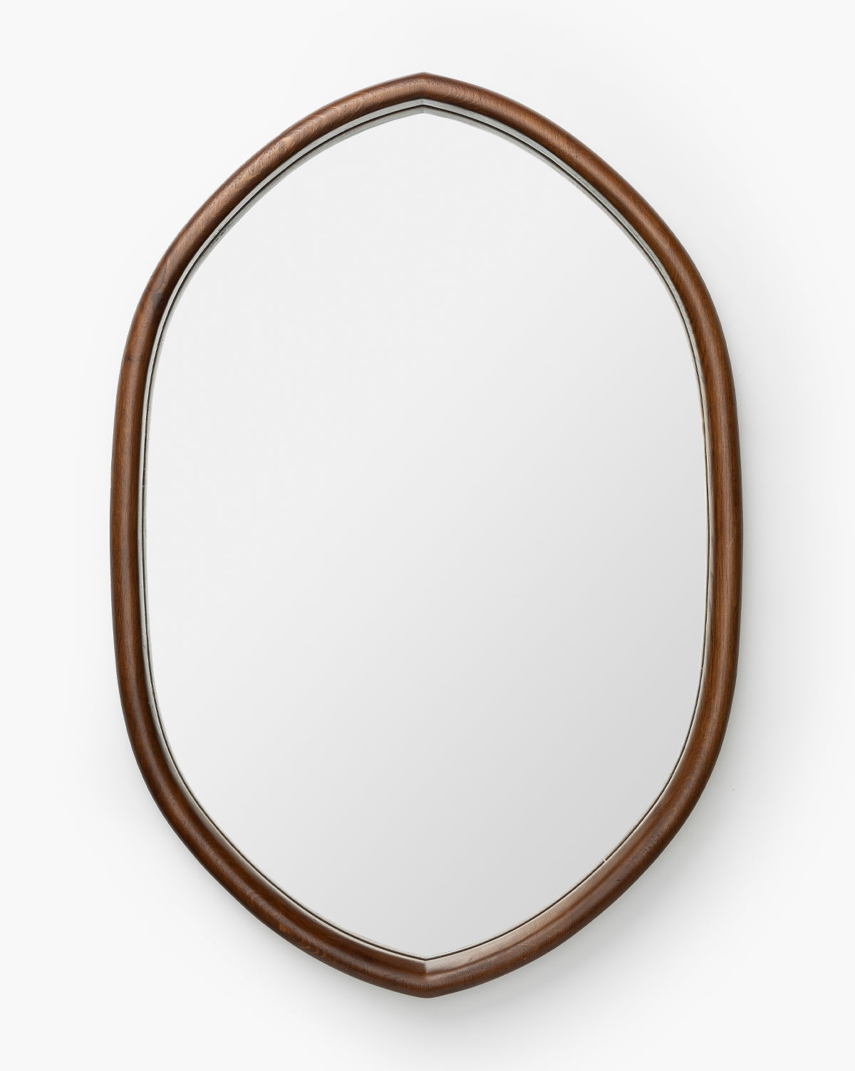 The Oslo Mirror has an oval shape with a smooth oak frame and gentle curves in a natural brown finish, set against a white background, by Vendixs