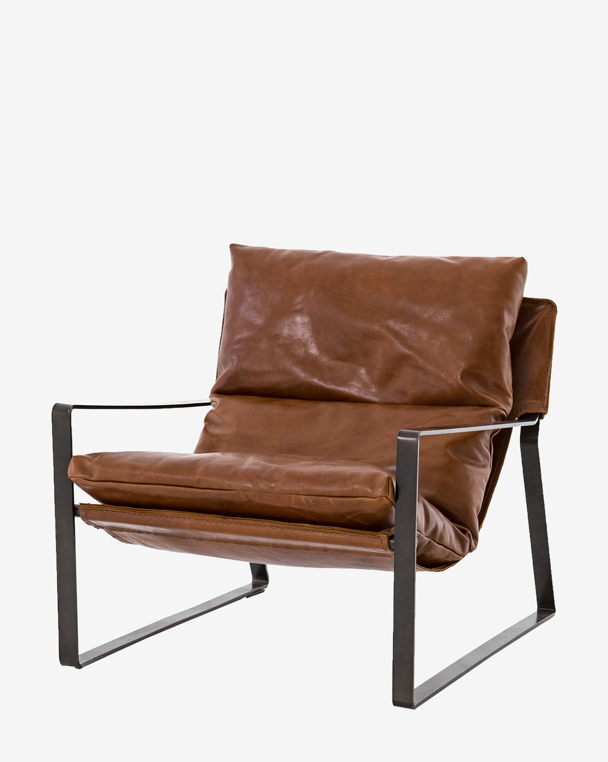 The Peyton Leather Sling Chair is a modern seat with plush brown leather cushions and a sleek black metal frame, open sides, and a minimalist design.